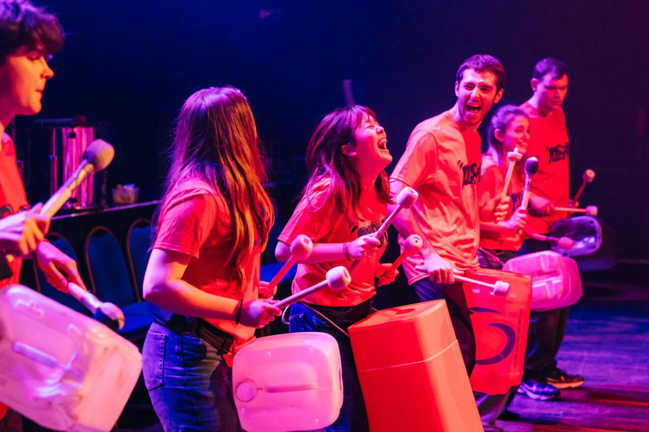 an image of a drummer laughing on stage